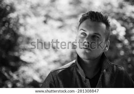 portrait of a young man who looks up black and white photography
