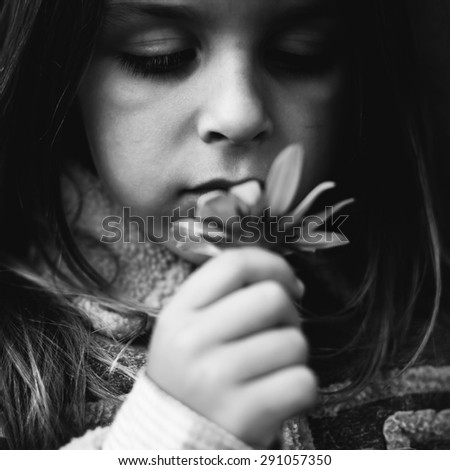 boy and yellow flower black and white photography