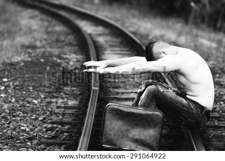 half-naked young man on a railway line black and white photography