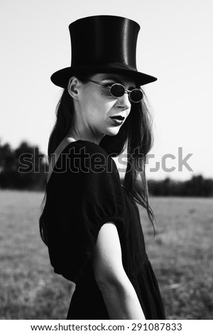 unusual girl with cylinder hat black and white photography