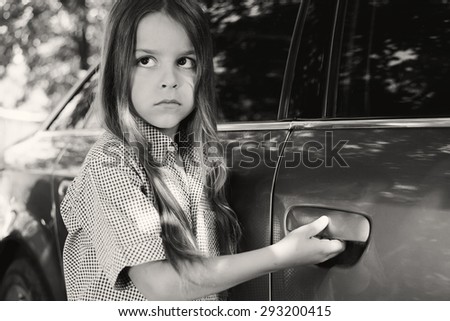 boy opens the car door black and white photography