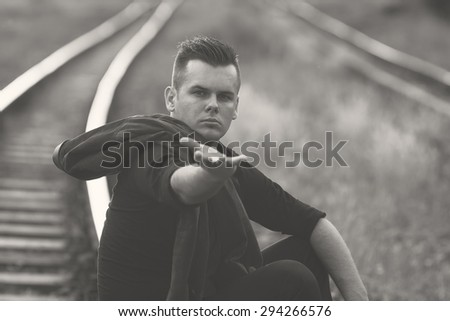 a young man with outstretched hand black and white photography