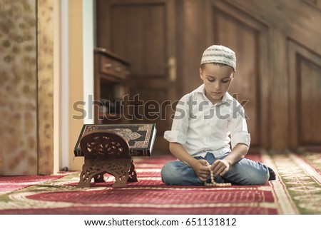 Ramadan Kareem,beautiful boy Muslim is praying in mosque,Peace and love in the holy month of Ramadan,lifestyle concept