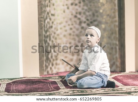 Ramadan Kareem,beautiful boy Muslim is praying in mosque,Peace and love in the holy month of Ramadan