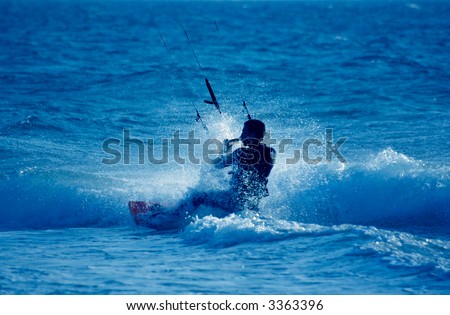 kite surfing, silhouette of sporstmen on blue