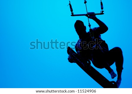 kite surfing, silhouette of sportsmen on blue