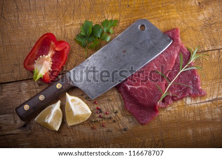 Butcher\'s still life with a cleaver, slices of raw beef and other stuff.