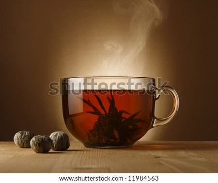 A glass bowl with hot Chinese tea.