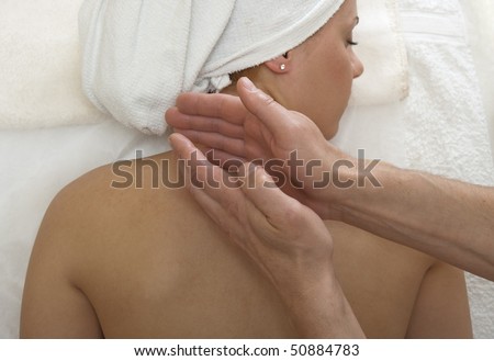 Woman is getting back massage from a physiotherapist.