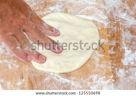 cook and stretches the dough for the pizza