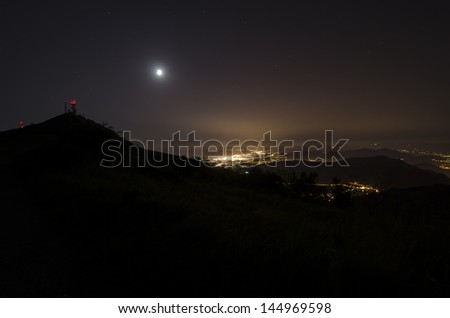 city of Genoa with the moon and the sea at night