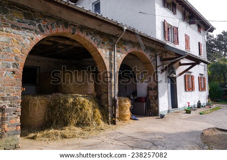 bales of hay in a barn brick