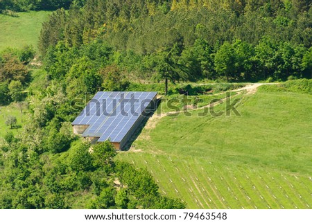 large greenhouse covered with solar panels on the hills of Italy in Predappio