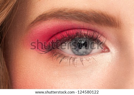 Close-up picture of beautiful female blue eye with bright fashion makeup