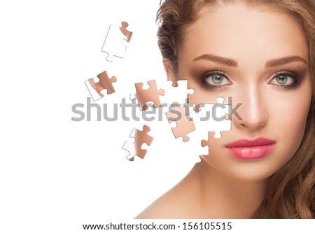 Face of  beautiful young woman with a puzzle collage of her skin, isolated on a white background