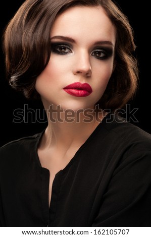 Portrait of attractive young woman with pink matt lipstick and  beautiful retro hairstyle