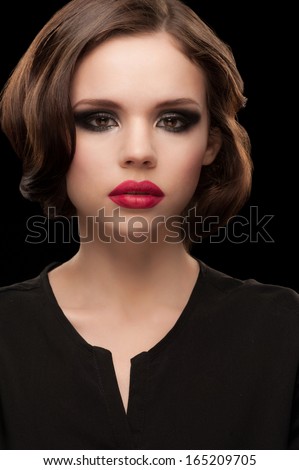 Portrait of attractive young woman with pink matt lipstick and beautiful retro hairstyle