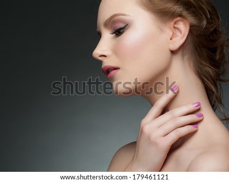 Studio portrait of beautiful young woman with stylish makeup and manicure