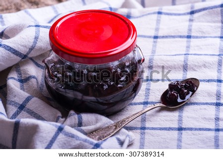 Berry jam jar over linen napkin