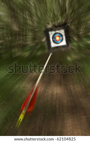 arrow flying towards archery target shoot