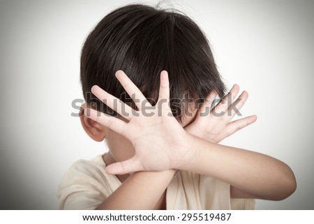 Child raising hands to protect itself