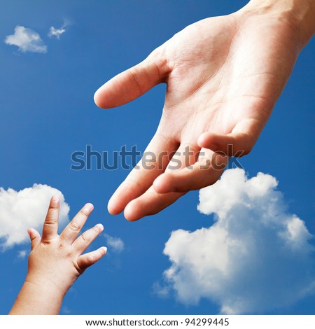 Connecting between adult hand and baby hand on sky