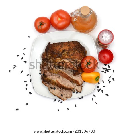 Baked pork on plate with tomatoes and peppers. Top view.