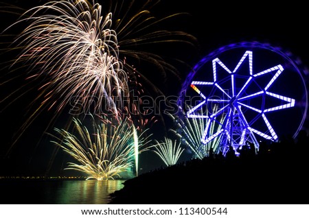 New Year's revelers watch fireworks display by bay, Philippines