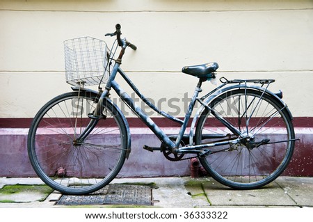 Old Chinese bicycle parked on sidewalk along a narrow street
