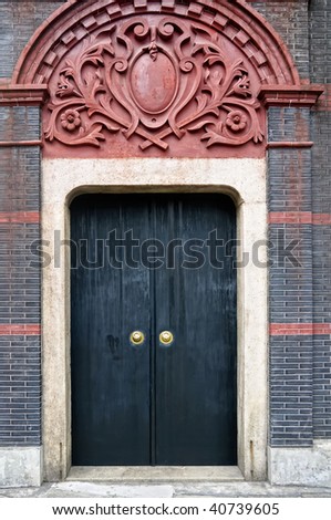 Black, heavy door of an old residential structure in Shanghai, China