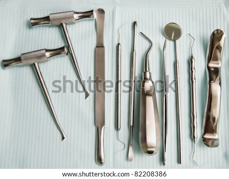 Various dental instruments on top of bib