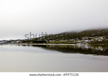 Landscape with lake, rocks and fog in Serra da Estrela ? mountain range in Portugal (Mountain Range of the Star)