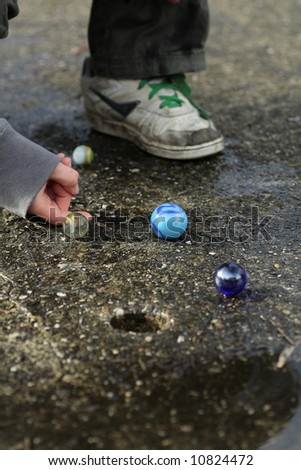 child playing a game with marbles