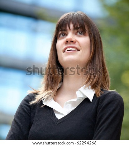 Thoughtful business woman portrait outdoors looking up