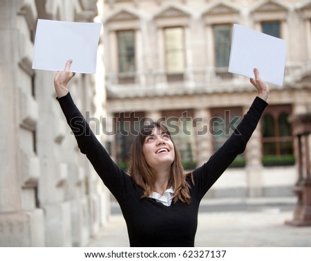 Happy master student outdoors with arms up