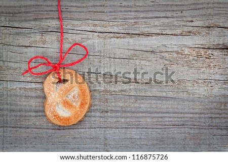 Christmas cookies biscuit, on the tape. On textured wood.