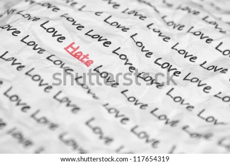 The word hate, love written on a crumpled piece of closeup.