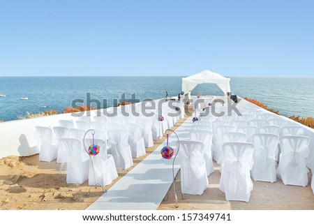 A marvelous place in the decorations and flowers for the wedding ceremony. With white chairs on the sea.