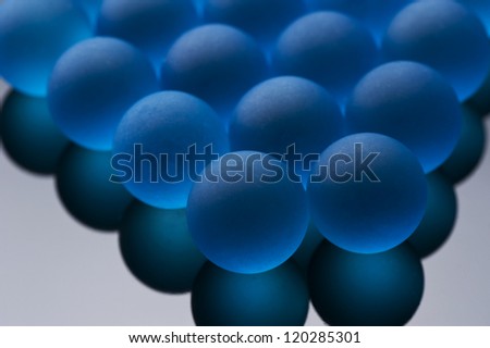 Many blue glass marbles on black background