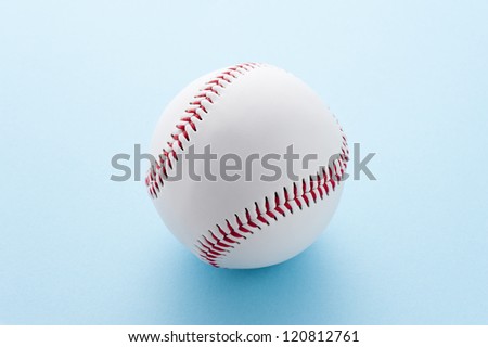 Baseball ball on light blue background