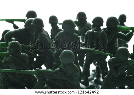 miniature toy soldiers with guns on white background