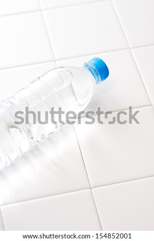 The bottled water on the tiled floor