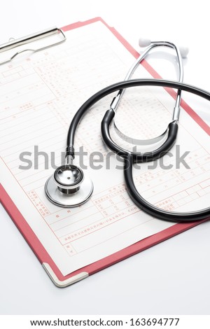 Medical record and Stethoscope on white background