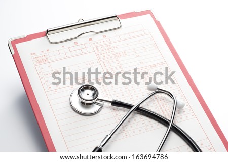 Medical record and Stethoscope on white background