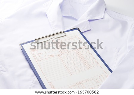 Medical records and lab coat medical