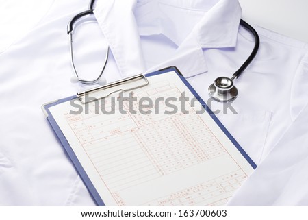 Stethoscope and medical records and lab coat medical