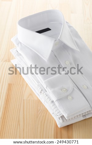 folded business shirt on wooden background