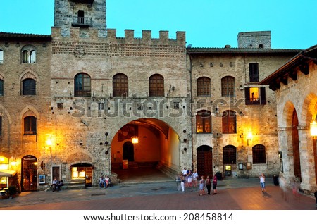 SAN GIMIGNANO,SIENA,  ITALY JUNE 24-Tourists walking at night in the medieval village-June 24 2014  San Gimignano, Siena, Italy