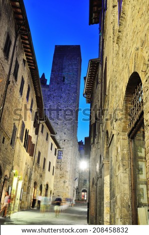 SAN GIMIGNANO,SIENA,  ITALY JUNE 24-Tourists walking at night in the medieval village-June 24 2014  San Gimignano, Siena, Italy