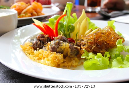 Thai food, rice in cold water served with fried sweet pork,fried egg and vegetable (khao chae)